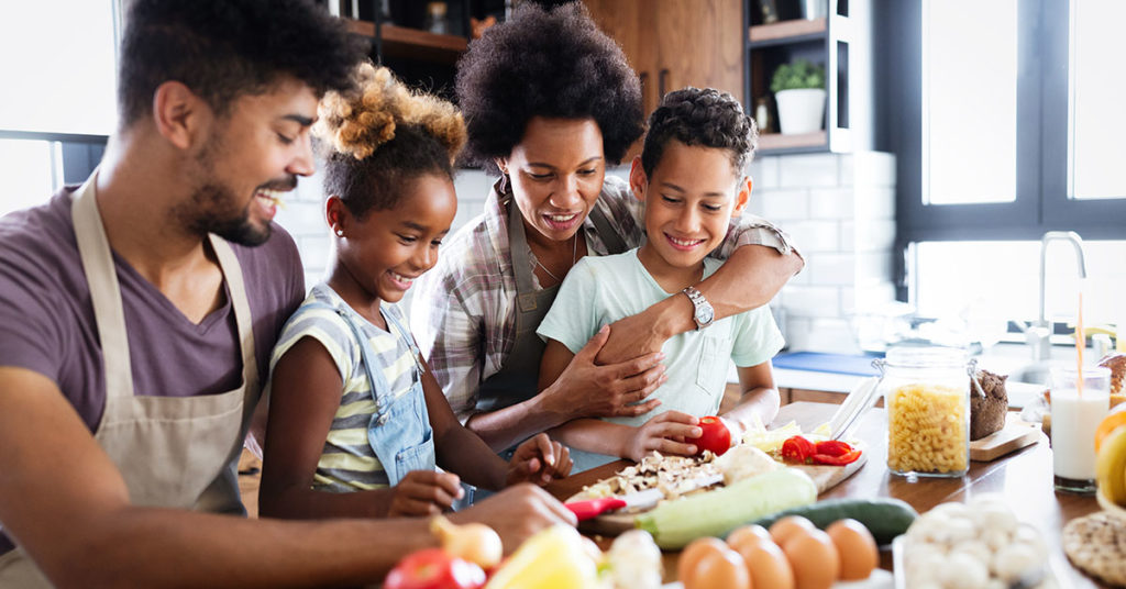 Happy family together preparing healthy food in the kitchen; blog: 6 Healthy Eating Habits for Kids