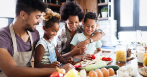 Happy family together preparing healthy food in the kitchen; blog: 6 Healthy Eating Habits for Kids