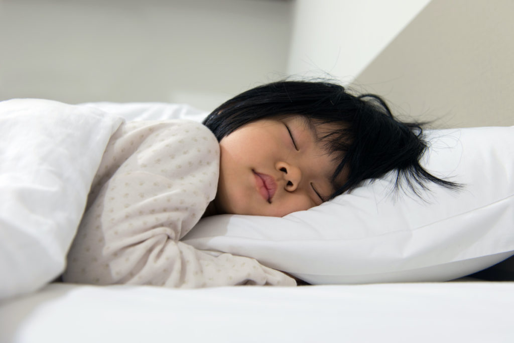 Portrait of Asian child sleeping on the bed; blog: Healthy Sleep Routines Tips and Tricks